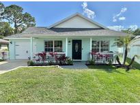 Charming single-story home featuring a cozy front porch and well-manicured lawn at 33635 Jeffery Ct, Leesburg, FL 34788