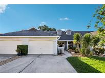 Charming single-story home with a two-car garage, well-maintained landscaping, and inviting curb appeal at 106 Baytree Blvd, Tavares, FL 32778
