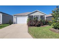 Charming single-story home with a well-maintained lawn, screened porch and a two-car garage at 1978 Lockett Ln, The Villages, FL 34762
