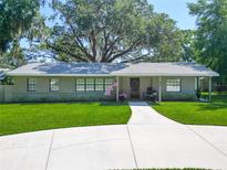 Beautiful single-story home featuring a well-maintained lawn, circular driveway, and inviting front porch at 203 Se 30Th Ave, Ocala, FL 34471