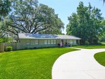 Charming single story home boasts a well-manicured lawn, mature trees, and a circular driveway at 203 Se 30Th Ave, Ocala, FL 34471