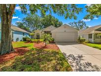 Charming single Gathering home with a well-manicured lawn, mature trees, and a two car garage at 3603 Westerham Dr, Clermont, FL 34711