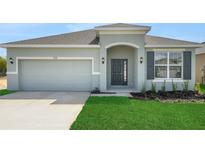 Charming single-story home with a well-manicured lawn, a two-car garage, and a welcoming front entrance at 4118 Penelope Ave, Lake Wales, FL 33859