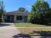 Charming single-story home with a well-maintained lawn and mature tree in a quiet neighborhood at 4294 Nimons St, Orlando, FL 32811