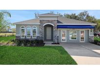 Beautiful single-story home with stone accents, arched windows, and a well-manicured lawn at 5039 Abigail Dr, Lake Wales, FL 33859