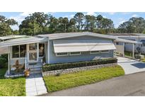 Well maintained single-story home with a manicured lawn and front porch at 150 Hickory Ln, Eustis, FL 32726