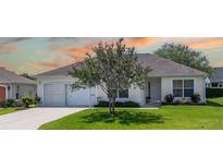 Charming single-story home with a well-manicured lawn and inviting front entrance at 1806 Estafana Way, The Villages, FL 32159