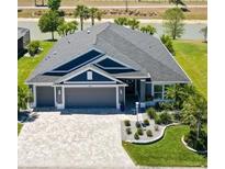 Beautiful single-Gathering home boasts a spacious driveway, three-car garage, and well-manicured landscaping at 2001 Dagenais Way, The Villages, FL 32163