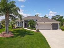Stunning single-story home showcasing lush landscaping, a spacious driveway, and a meticulously maintained lawn at 27027 Old English Ct, Leesburg, FL 34748