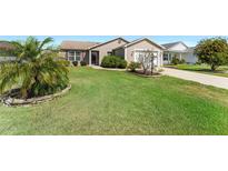 Well-maintained single-story home with landscaped front yard and inviting curb appeal at 3396 Greenacres Ter, The Villages, FL 32163