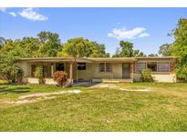 Charming single-story home with a covered porch and well-maintained lawn, perfect for relaxing outdoors at 2928 Delaney St, Orlando, FL 32806