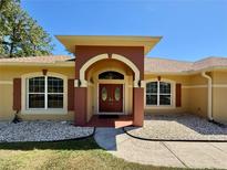 Inviting entryway with a double door entry and decorative pillars at 30554 Quince Ave, Eustis, FL 32736