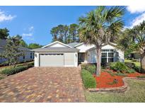 Charming single-story home featuring a brick driveway and well-maintained landscaping at 10282 Julia Isles Ave, Oxford, FL 34484