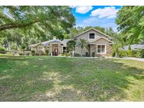 Charming single-Gathering home with stone accents, mature landscaping, and a well-manicured lawn at 10851 Lantana Crst, Clermont, FL 34711