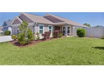 Charming home featuring a well-manicured lawn and nicely landscaped front yard at 2919 Gulley Ln, The Villages, FL 32163