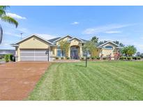 Inviting single-story home with a well-manicured lawn and a charming front entrance at 5433 County Road 125, Wildwood, FL 34785