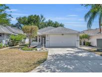 Charming single Gathering home with a well-manicured lawn and two car garage at 5614 King James Ave, Leesburg, FL 34748