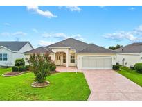 Charming single-story home boasts a well-manicured lawn and a spacious two-car garage at 2120 Callaway Dr, The Villages, FL 32162