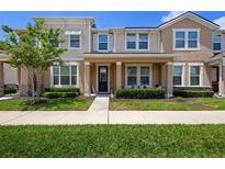 Inviting townhome showcasing well-maintained landscaping, a cozy porch, and a welcoming entryway at 2202 Garden Belle Dr, Clermont, FL 34711