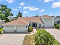 Attractive single-Gathering home featuring a three-car garage and a meticulously landscaped front yard at 4320 Heritage Trl, Leesburg, FL 34748