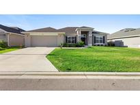 Charming single-story home with a well-manicured lawn and neutral-toned exterior at 5890 Sw 83Rd St, Ocala, FL 34476