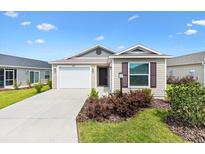 Charming single-story home with well-manicured lawn and a two car garage at 6471 Ecoff Pl, The Villages, FL 34762