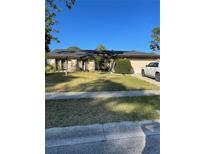 Charming single-story home with a well-manicured lawn and mature landscaping in a quiet neighborhood at 879 Little Bend Rd, Altamonte Springs, FL 32714