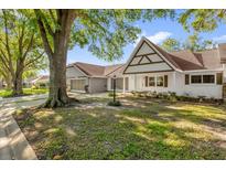 Charming single-story home featuring a brick facade, shuttered windows, and a well-manicured lawn at 8814 Sw 93Rd Ln # B, Ocala, FL 34481