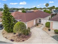 Charming single-story home showcasing meticulous landscaping and a spacious driveway at 632 Delgado Ave, The Villages, FL 32159