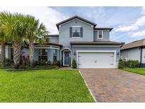 Charming two-story home with a brick driveway, lush landscaping, and inviting curb appeal at 1268 Patterson Ter, Lake Mary, FL 32746
