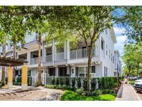 Charming townhome with gray exterior, white balconies, and lush landscaping in a desirable community at 1795 Piedmont Pl, Lake Mary, FL 32746