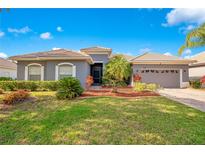 Charming single-story home with well-manicured lawn and tiled roof under blue skies at 2641 Meadow View Ct, Kissimmee, FL 34746