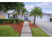 Charming single-story home with well-manicured landscaping and inviting entryway at 506 Weston Manor Dr, The Villages, FL 32162