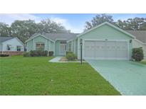 Charming single-story home with a well-maintained lawn and attached two-car garage at 739 Cortez Ave, The Villages, FL 32159