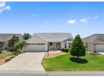 Charming one-story home with well-manicured lawn, concrete driveway, and attached two-car garage at 951 Chapman Loop, The Villages, FL 32162