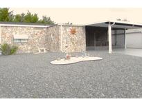 Charming home featuring a unique stone facade and a well-maintained gravel yard at 1014 Dustin Dr, Lady Lake, FL 32159