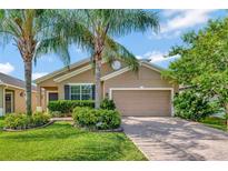 Charming single-story home featuring a well-maintained lawn and mature palm trees, creating a welcoming curb appeal at 15322 Veramonte Way, Orlando, FL 32828