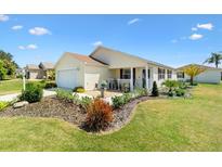 Charming single-story home with well-manicured lawn and landscaping, offering great curb appeal at 2167 Kerwood Loop, The Villages, FL 32162