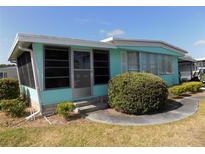 Charming single-story home featuring a screened room and well-maintained landscaping at 323 Hawthorne Blvd, Leesburg, FL 34748