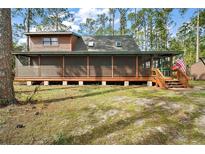 Secluded cabin home featuring a screened porch and mature trees, perfect for nature lovers at 41513 Aspen St, Eustis, FL 32736