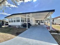 Charming single-story home featuring a covered parking area and well-maintained landscaping at 519 Hawthorne Blvd, Leesburg, FL 34748