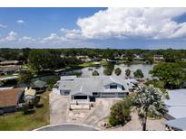 Stunning aerial view of home on a waterfront lot with boat docks and private drive at 5339 Kings Ct, Fruitland Park, FL 34731