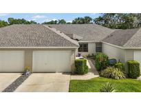 Charming home with a one-car garage, neat landscaping, and a welcoming pathway at 579 Juniper Way, Tavares, FL 32778