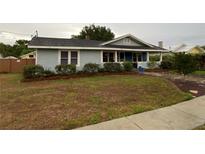 Charming single story home with light blue siding and well-manicured landscaping around the front at 604 N Old Wire Rd, Wildwood, FL 34785