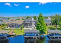 Expansive lake view home featuring boat docks, a screened lanai, and a private pool for waterfront living at 722 Barefoot Bay Loop, Clermont, FL 34736