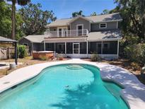 A beautiful backyard pool with a spa, gazebo and screened-in porch offer outdoor living at its finest at 26 Weston Rd, Leesburg, FL 34748