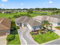 Stunning home with manicured lawn and a picturesque golf course view at 11820 Se 178Th St, Summerfield, FL 34491