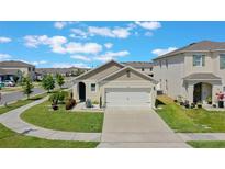 Well-maintained, single-story home featuring a two-car garage, nicely landscaped front yard, and neutral color scheme at 1548 Planters Point Rd, Kissimmee, FL 34744