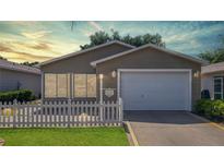 Charming single-story home featuring a well-manicured lawn and attached two-car garage at 2039 Thurmond Ave, The Villages, FL 32162