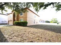 Charming two-story home with attached garage and well-maintained landscaping in a suburban neighborhood at 3329 White Blossom Ln, Clermont, FL 34711